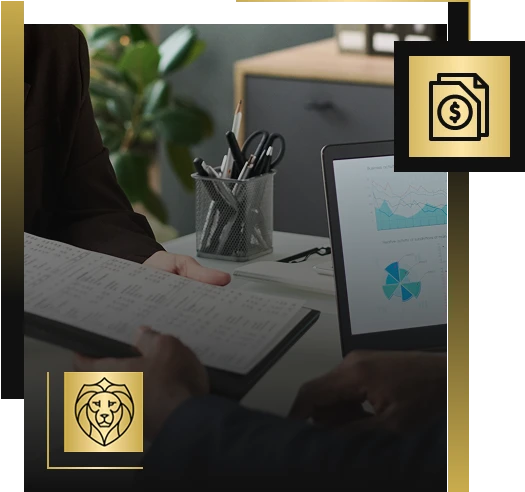 Two people sit at a desk with financial charts on a laptop and a notebook, representing Lyon Property Group. Office supplies and a plant are in the background, highlighting professional property management in Rhode Island and Eastern Connecticut.