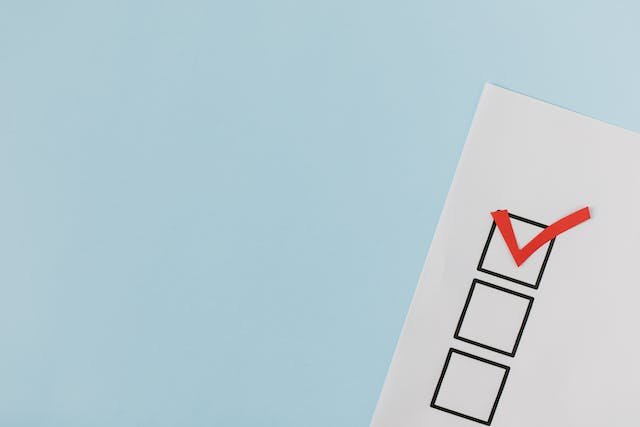 A paper with three checkboxes appears on a light blue background—perfect for Property Management tasks. The top checkbox has a red checkmark, while the other two are empty, reflecting Lyon Property Group’s approach in Rhode Island and Eastern Connecticut.